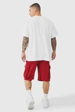Shop boohooMAN Baggy Fit Elasticated Waist Extended Drawcord Cargo Shorts red