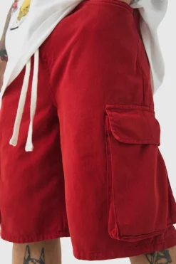 Shop boohooMAN Baggy Fit Elasticated Waist Extended Drawcord Cargo Shorts red