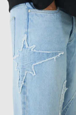 New boohooMAN Baggy Rigid All Over Raw Edge Applique Jeans light blue