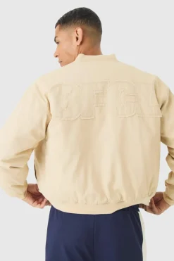 Shop boohooMAN Boxy OFCL Applique Twill Padded Bomber Jacket In stone
