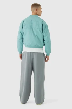 Fashion boohooMAN Boxy OFCL Applique Twill Padded Bomber Jacket In light blue