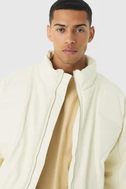 Online boohooMAN Boxy Padded Moto Panelled Jacket In ecru
