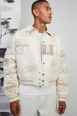 Online boohooMAN Boxy Pu Tonal Badge Varsity Jacket ecru