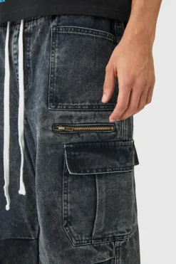 Shop boohooMAN Elastic Waist Acid Wash Parachute Cargo Jeans In black