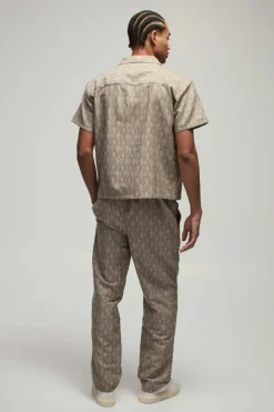 Shop boohooMAN Elastic Waist Straight Woven Geo Trouser stone