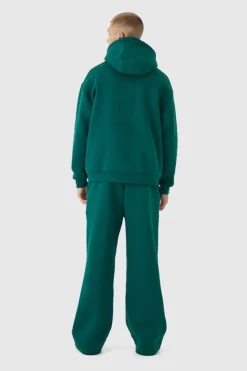 Shop boohooMAN Embossed Worldwide Wide Leg Jogger forest