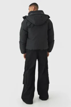 Store boohooMAN Gothic M Extreme Heavy Filled Hooded Puffer Coat In black