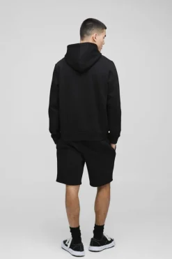 Shop boohooMAN Loose Fit Mid Length BM Signature Shorts black