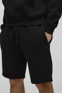 Shop boohooMAN Loose Fit Mid Length BM Signature Shorts black