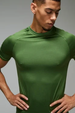 Shop boohooMAN Man Active Lightweight Essentials Gym Muscle Fit Raglan T-shirt green