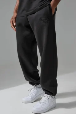 Shop boohooMAN Man Active Training Dept Oversized Embossed Jogger black