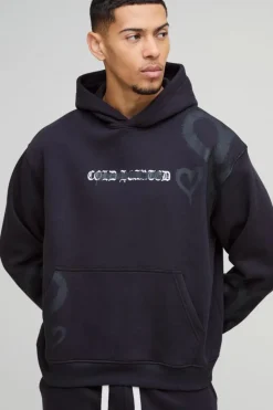 Shop boohooMAN Oversized Boxy All Over Heart Printed Hoodie black