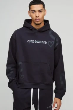 Shop boohooMAN Oversized Boxy All Over Heart Printed Hoodie black