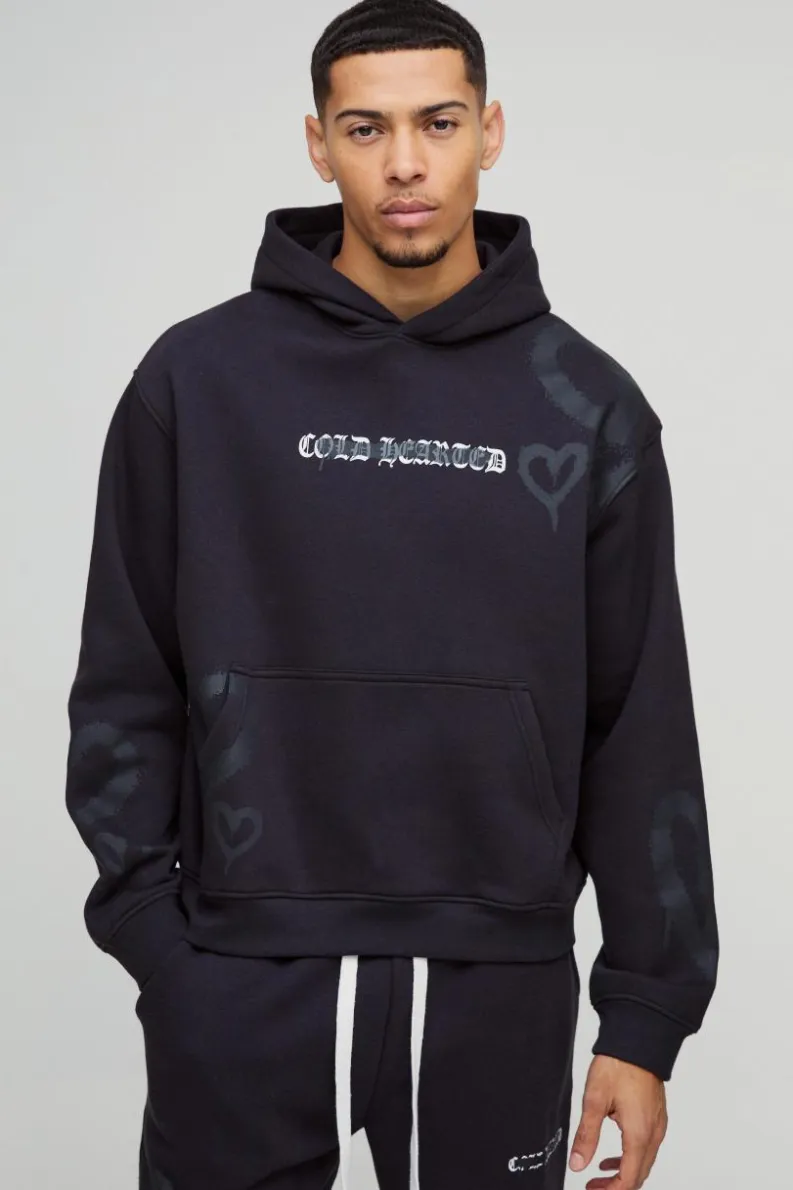Shop boohooMAN Oversized Boxy All Over Heart Printed Hoodie black