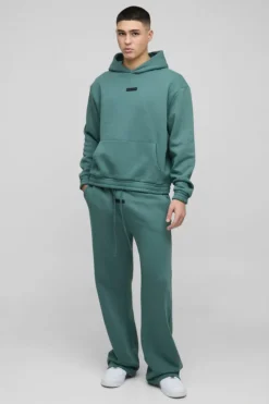 Store boohooMAN Oversized Boxy Flare Stacked Hooded Tracksuit With Rubber Badge forest
