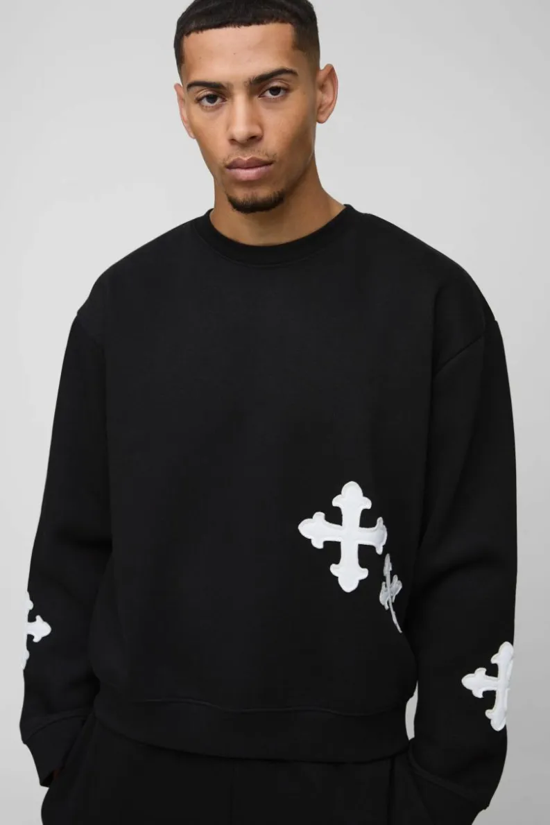 Shop boohooMAN Oversized Boxy Gothic Cross Applique Sweatshirt black