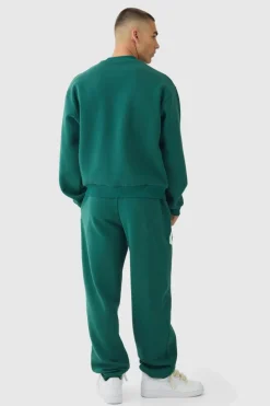 Shop boohooMAN Oversized Boxy Varsity Print Sweatshirt Tracksuit forest