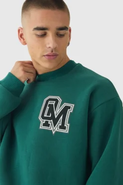 Shop boohooMAN Oversized Boxy Varsity Print Sweatshirt Tracksuit forest