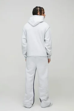 Store boohooMAN Oversized Boxy Varsity Worldwide Printed Raw Hem Flare Hooded Tracksuit grey