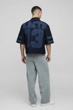 Shop boohooMAN Oversized Boxy V Neck Laser Print Football Top indigo