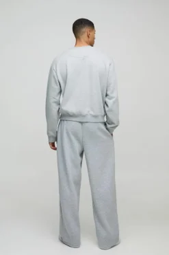 Shop boohooMAN Oversized Boxy Worldwide Distressed Applique Sweatshirt grey marl