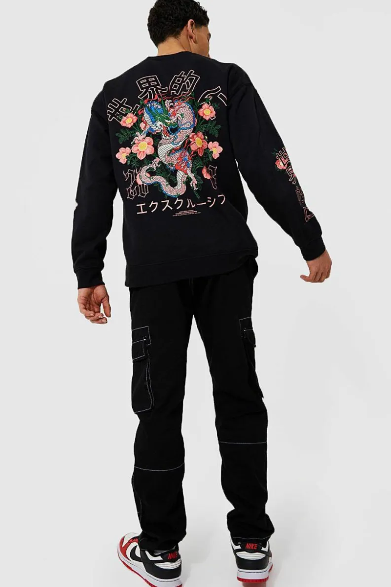 Shop boohooMAN Oversized Dragon Floral Graphic Sweatshirt black