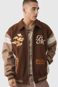 Online boohooMAN Oversized Floral Badge Collared Varsity Jacket In brown