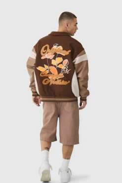 Online boohooMAN Oversized Floral Badge Collared Varsity Jacket In brown