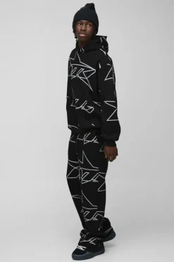 Online boohooMAN Oversized Star All Over Printed Gusset Flare Hooded Tracksuit black