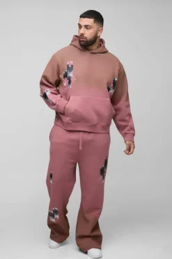 Shop boohooMAN Plus Oversized Boxy Applique Cross Spray Wash Hooded Relaxed Flare Tracksuit brown