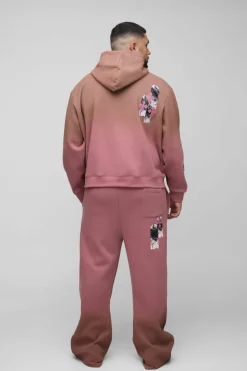 Shop boohooMAN Plus Oversized Boxy Applique Cross Spray Wash Hooded Relaxed Flare Tracksuit brown