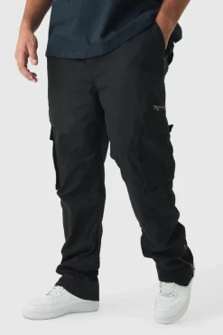 Shop boohooMAN Plus Slim Flare Zip Gusset Overdye Acid Wash Cargo Trouser In black