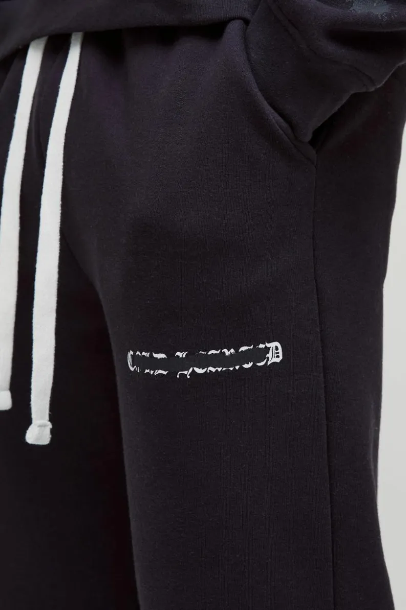Store boohooMAN Relaxed Fit All Over Heart Printed Jogger black