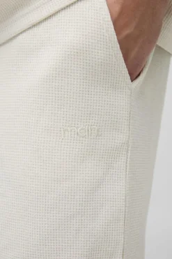 Shop boohooMAN Relaxed Man Embroidered Waffle Shorts ecru
