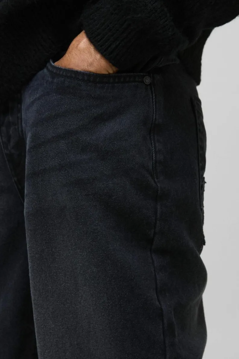 Shop boohooMAN Relaxed Rigid Acid Wash Applique Denim Jeans black