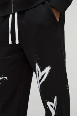 Hot boohooMAN Relaxed Split Hem Heart Jogger black