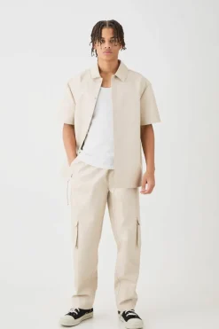 Shop boohooMAN Short Sleeve Drop Shoulder Pu Overshirt & Cargo Trouser Set beige