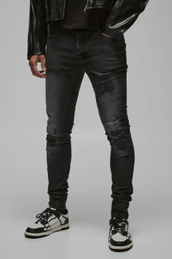 Shop boohooMAN Skinny Stretch Stacked Biker Rip & Repair Jeans true black