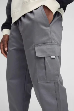Best Sale boohooMAN Slim Fit Elasticated Waist Woven Tab Cuffed Cargo Trousers charcoal