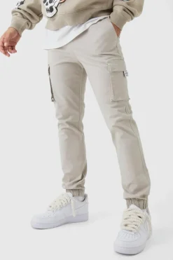 Store boohooMAN Slim Fit Elasticated Waist Woven Tab Cuffed Cargo Trousers stone