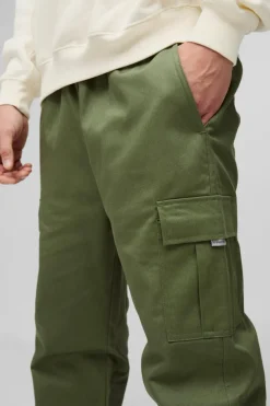 Shop boohooMAN Slim Fit Elasticated Waist Woven Tab Cuffed Cargo Trousers khaki