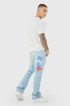 Shop boohooMAN Slim Rigid Flare Applique Jeans In ice blue