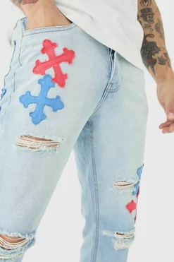 Shop boohooMAN Slim Rigid Flare Applique Jeans In ice blue