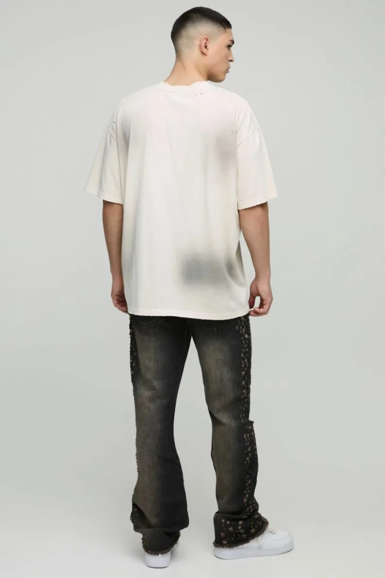 Shop boohooMAN Slim Rigid Flared Stacked Distressed Washed Jeans brown