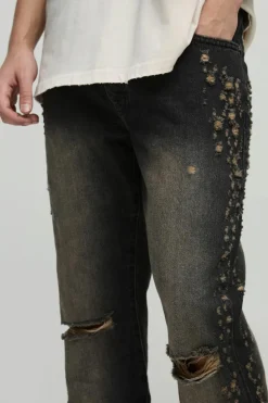 Shop boohooMAN Slim Rigid Flared Stacked Distressed Washed Jeans brown