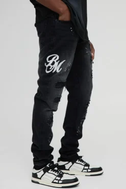 Shop boohooMAN Slim Rigid Paint Splat Ripped Jeans washed black