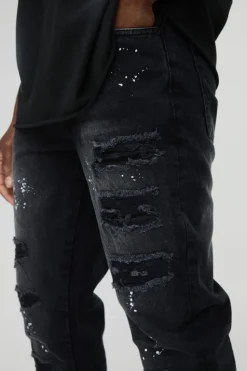 Shop boohooMAN Slim Rigid Paint Splat Ripped Jeans washed black