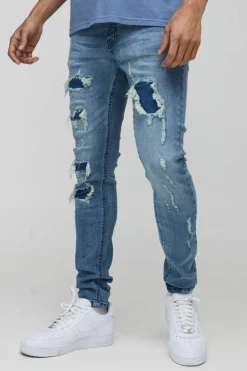 Online boohooMAN Super Distressed Dirty Wash Skinny Jeans mid wash