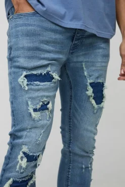 Online boohooMAN Super Distressed Dirty Wash Skinny Jeans mid wash