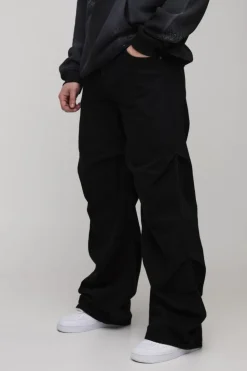 Shop boohooMAN Tall Baggy Ruched Detail Jeans washed black